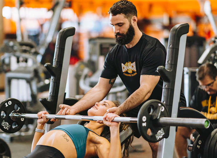 woman with her crunch personal trainer