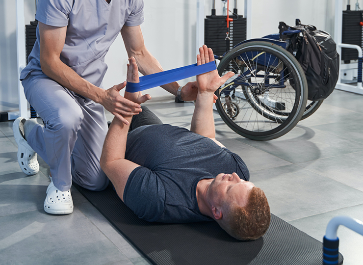 Man on yoga mat using resistance band