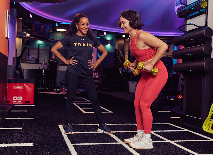 Personal trainer with their client at the gym