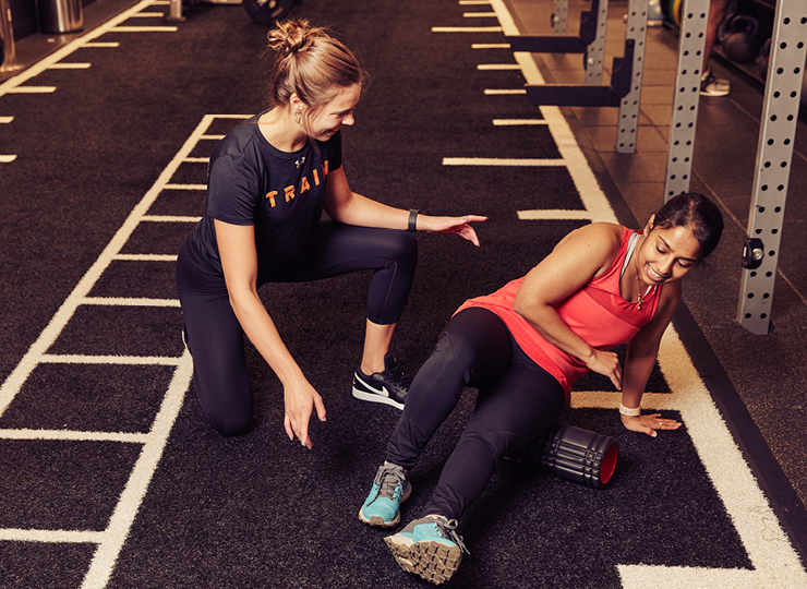 Client foam rolling with their trainer