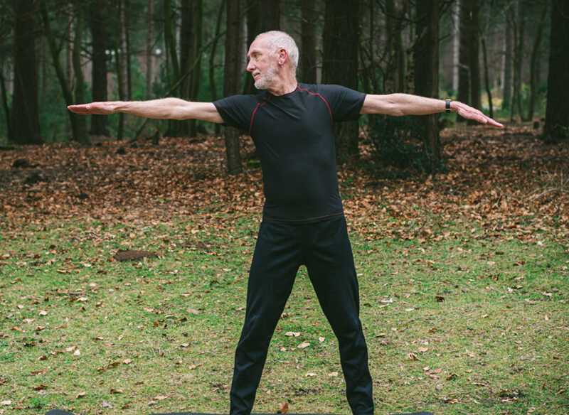 old man holding a yoga pose