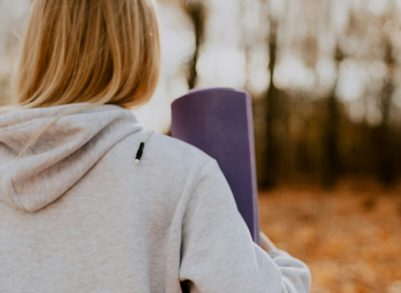 woman with a yoga mat