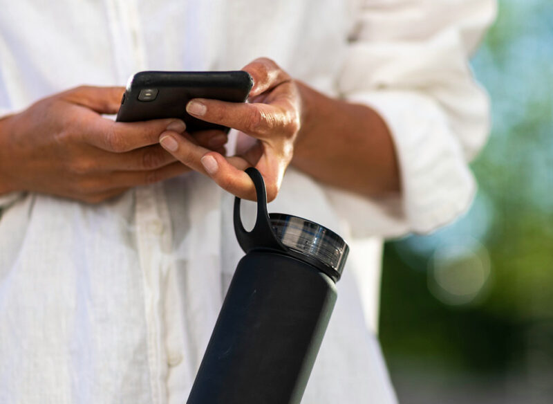 woman holding a water bottle